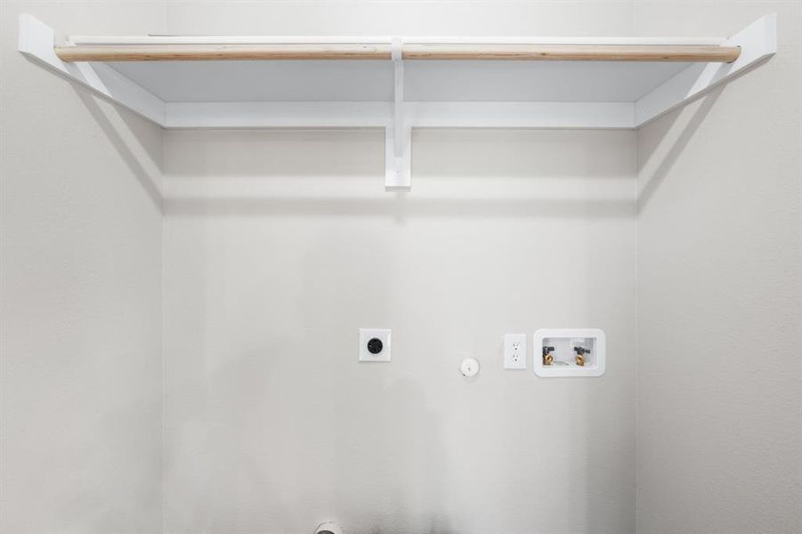 Laundry room featuring gas dryer hookup, hookup for an electric dryer, and hookup for a washing machine Laundry room featuring gas dryer hookup, hookup for an electric dryer, and hookup for a washing machine