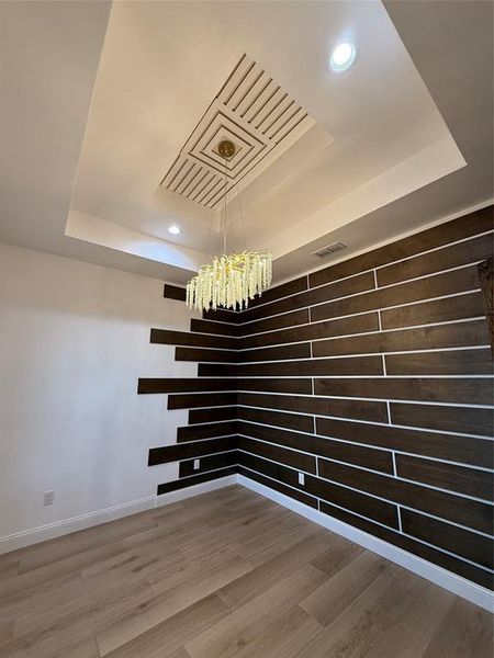 Unfurnished room featuring a tray ceiling, light wood finished floors, and recessed lighting Unfurnished room featuring a tray ceiling, light wood finished floors, and recessed lighting