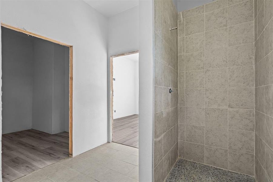 Bathroom with a stall shower and tile patterned floors Bathroom with a stall shower and tile patterned floors