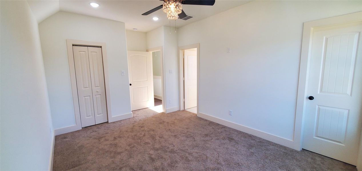 Primary bedroom with a his and her closet.
