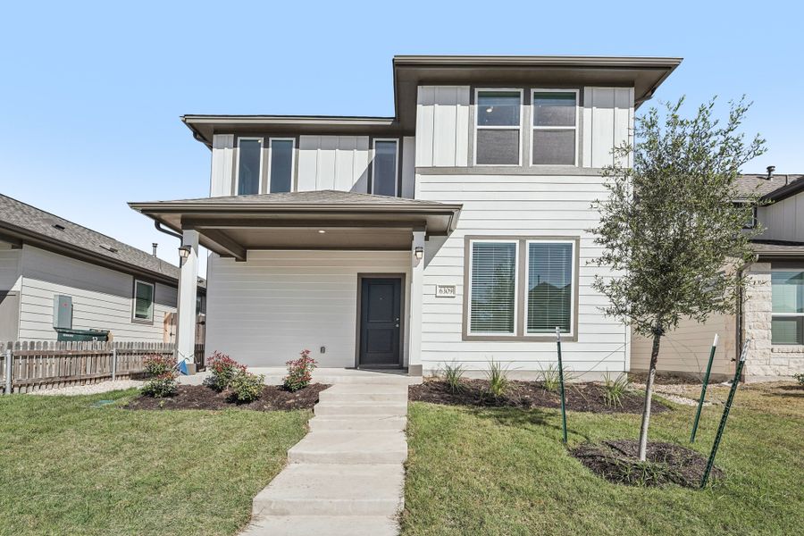 Front exterior of a new home in Porter Country, Buda, TX, highlighting curb appeal (Image 1).