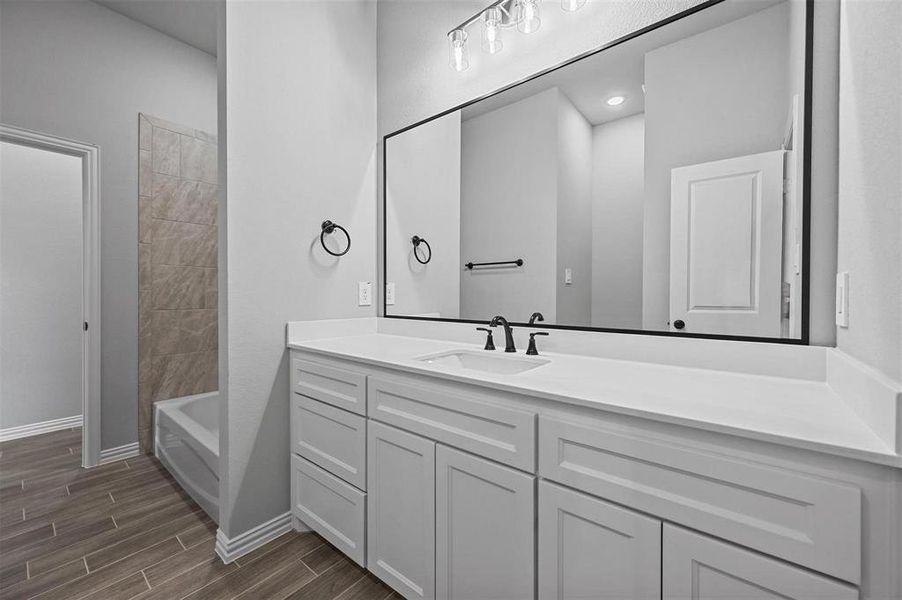 Full bathroom featuring vanity, and shower / bath combination Full bathroom featuring vanity, and shower / bath combination