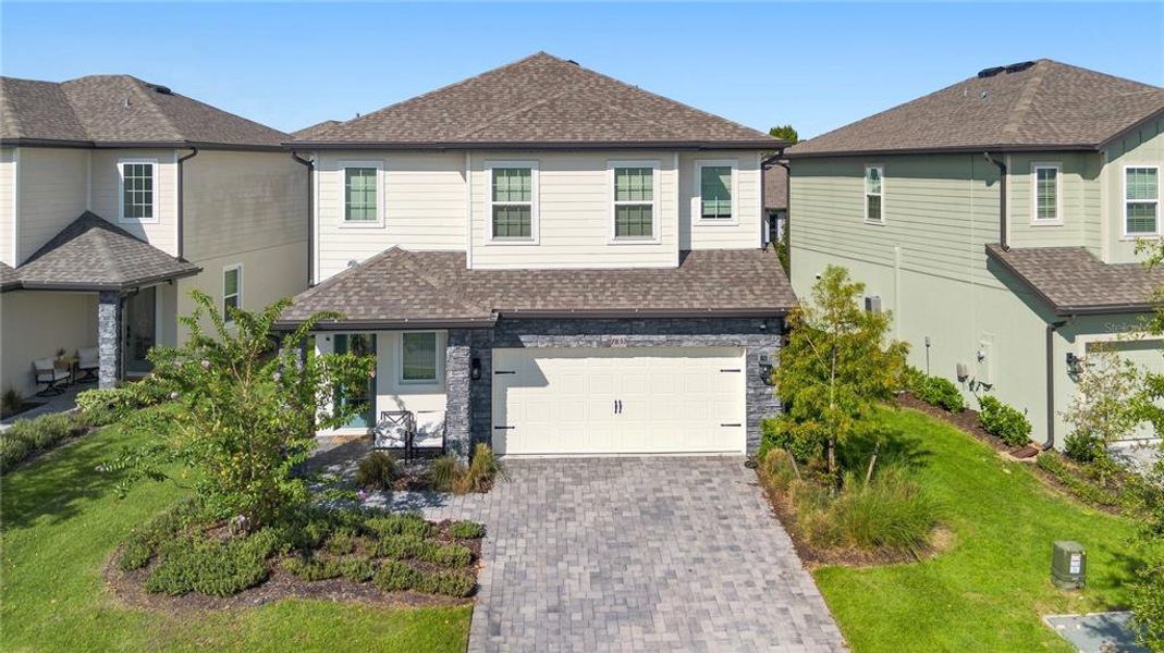 Front exterior of a new home in Reunion Village, Kissimmee, FL, highlighting curb appeal (Image 29).