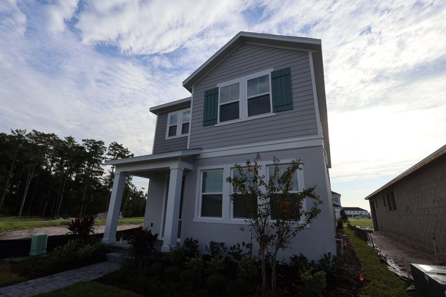 Front exterior of a new home in Palmeras at Crossprairie – The Magnolia Collection, St. Cloud, FL, highlighting curb appeal (Image 6). Front exterior of a new home in Palmeras at Crossprairie – The Magnolia Collection, St. Cloud, FL, highlighting curb appeal (Image 6).