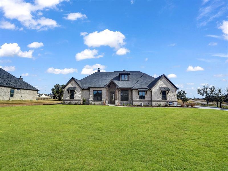 French country home featuring a front lawn