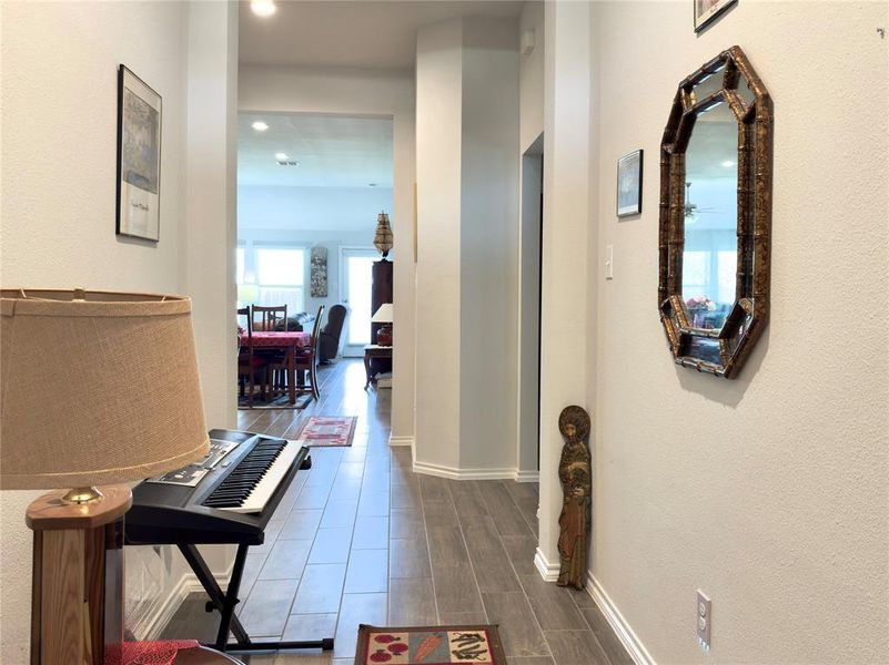 Hallway with wood tiled floors and a textured wall Hallway with wood tiled floors and a textured wall