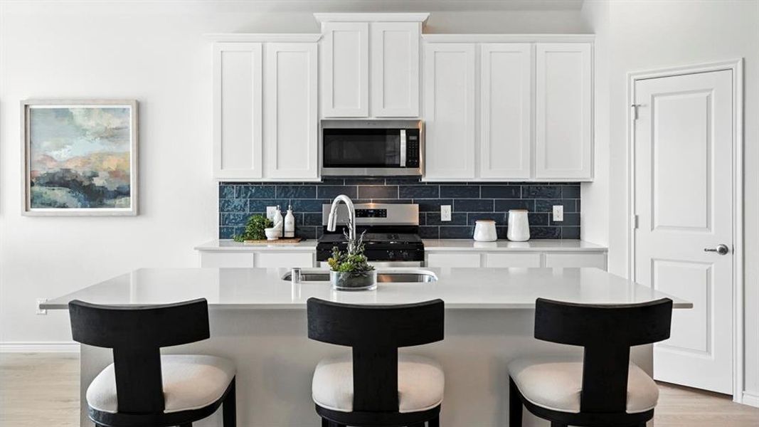 Kitchen island with a stainless steel sink and gooseneck faucet