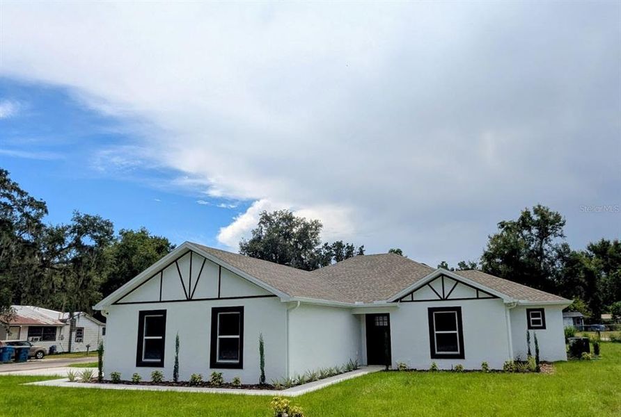 Front exterior of a new home in , Fort Meade, FL, highlighting curb appeal (Image 1).
