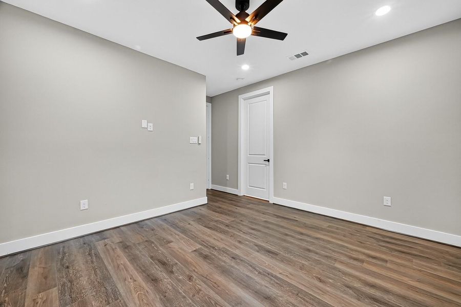 An upstairs retreat awaits—versatile by design, whether imagined as a media lounge, creative hub, or playful corner. Recessed lighting and a ceiling fan set the stage for possibility.