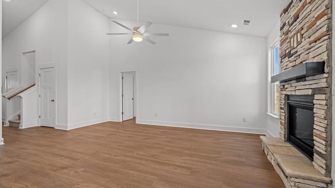 Vibrant family room with high-impact two-story ceilings and thoughtful layout for entertaining