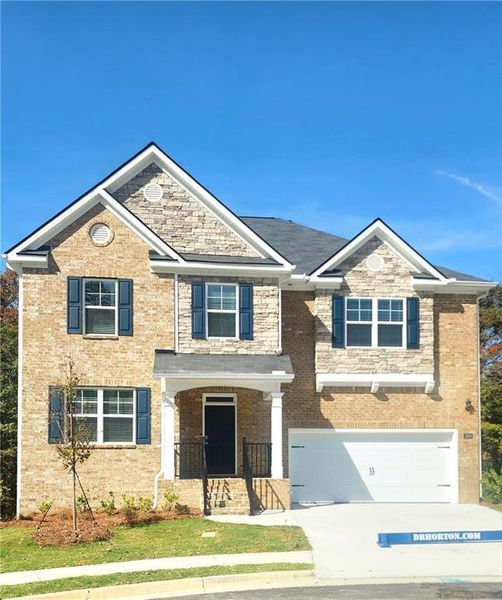 Front exterior of a new home in Brooks Station, Dacula, GA, highlighting curb appeal (Image 1).
