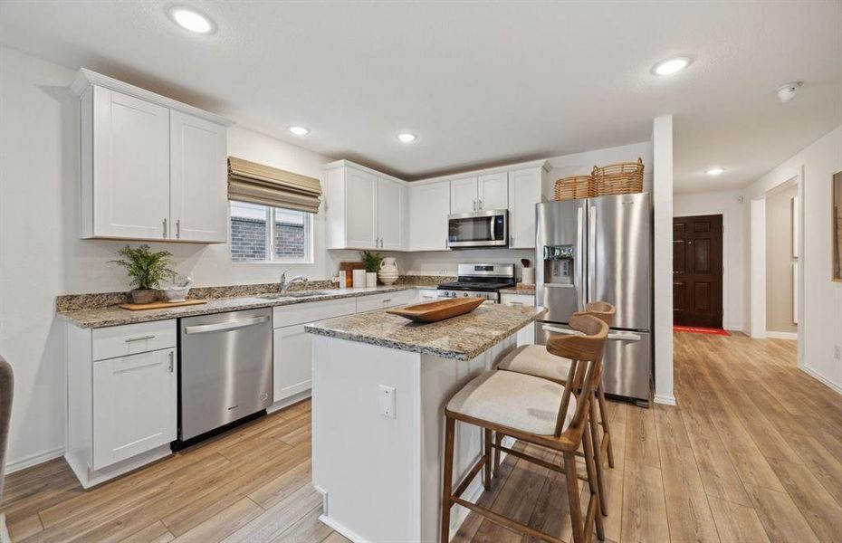 Spacious kitchen with eat-in bartop island *Model Representation*