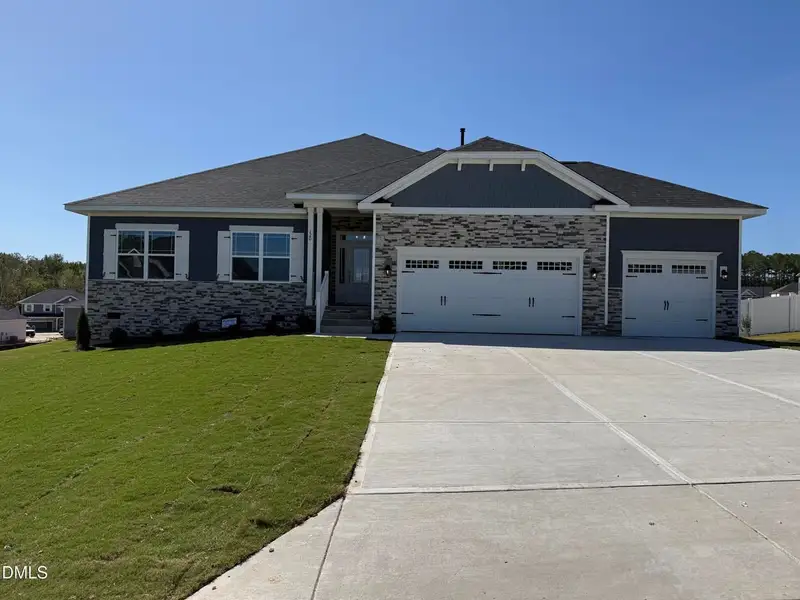 Front exterior of a new home in Kelly Farms, Lillington, NC, highlighting curb appeal (Image 1). Front exterior of a new home in Kelly Farms, Lillington, NC, highlighting curb appeal (Image 1).