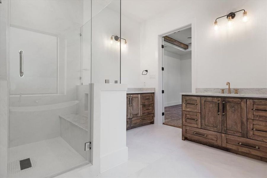 Bathroom featuring an enclosed shower, tile flooring, and vanity