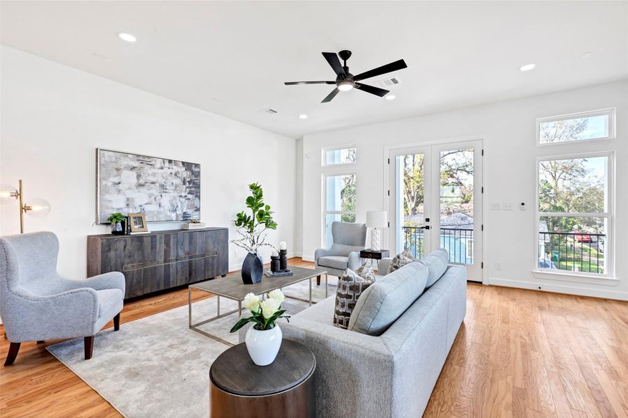 Another angle of this stunning living room, featuring beautiful wooden floors and direct access to the balcony, perfect for indoor-outdoor living. (Representation of previously built homes. Actual colors and finishes will vary.) Another angle of this stunning living room, featuring beautiful wooden floors and direct access to the balcony, perfect for indoor-outdoor living. (Representation of previously built homes. Actual colors and finishes will vary.)