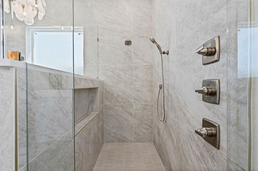 Full bathroom featuring a tile shower Full bathroom featuring a tile shower