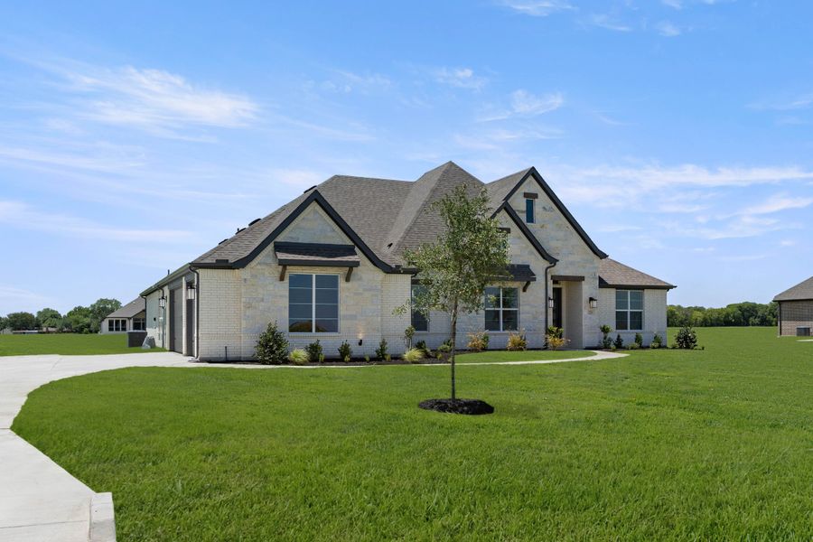 Front exterior of a new home in Pecan Acres, Red Oak, TX, highlighting curb appeal (Image 2). Front exterior of a new home in Pecan Acres, Red Oak, TX, highlighting curb appeal (Image 2).