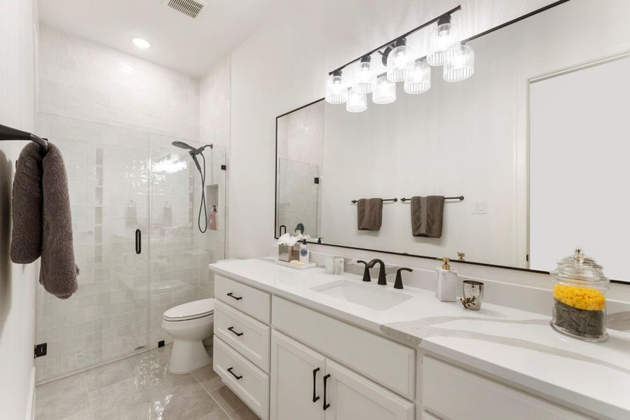 This Secondary bath was extended and features to the ceiling tile and a clean, polished finish. Private bath access for each bedroom creates excellent comfort for guests or household members.