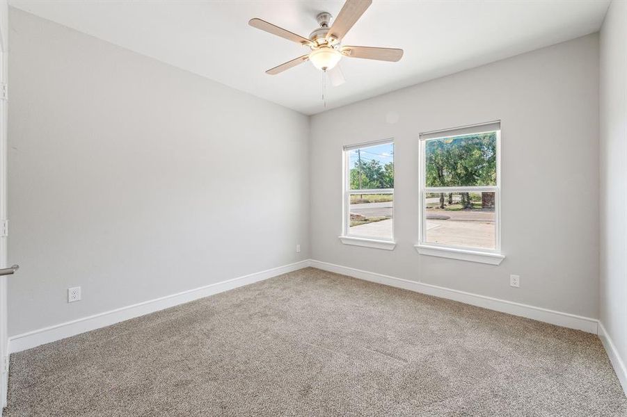 Unfurnished room featuring light colored carpet and ceiling fan Unfurnished room featuring light colored carpet and ceiling fan