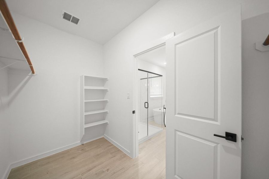 Walk-in closet in the primary suite (*Photo not of actual home and used for illustration purposes only.) Walk-in closet in the primary suite (*Photo not of actual home and used for illustration purposes only.)
