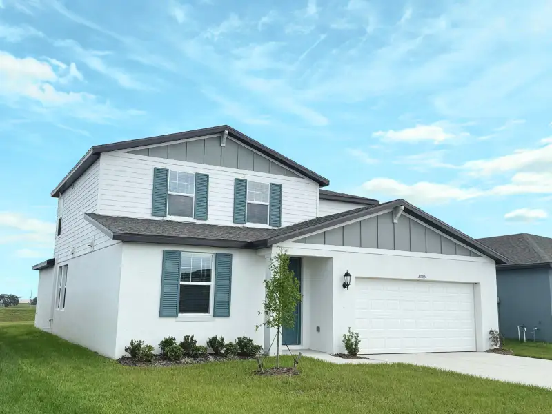 Front exterior of a new home in Benton Hills - Classic Series, Brooksville, FL, highlighting curb appeal (Image 1). Front exterior of a new home in Benton Hills - Classic Series, Brooksville, FL, highlighting curb appeal (Image 1).