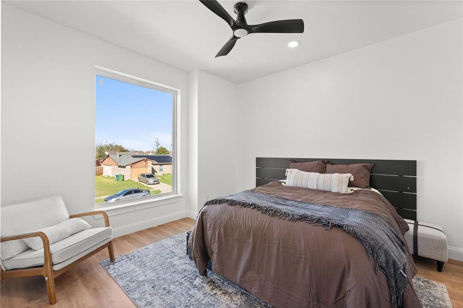 Bedroom with wood finished floors, a ceiling fan, and recessed lighting