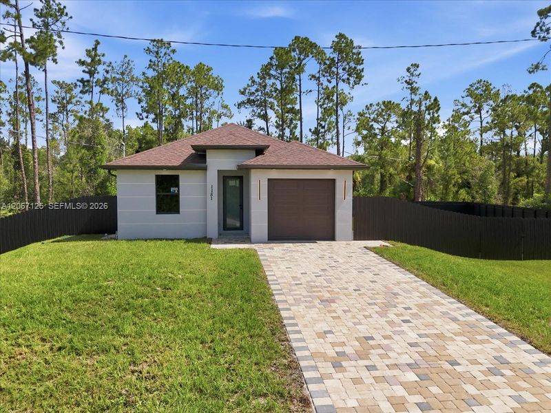 Front exterior of a new home in , Lehigh Acres, FL, highlighting curb appeal (Image 24).