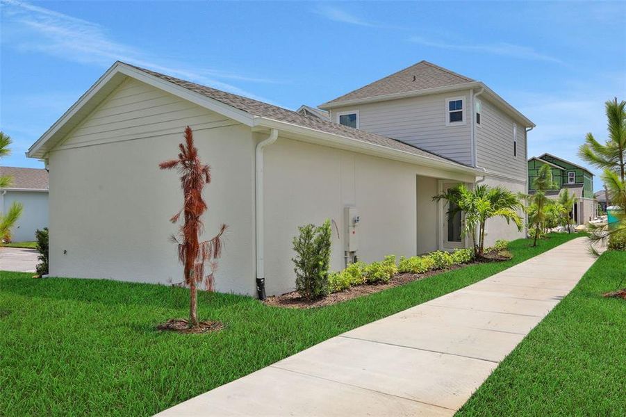 Front exterior of a new home in Bungalow Walk at Lakewood Ranch, Sarasota, FL, highlighting curb appeal (Image 22).