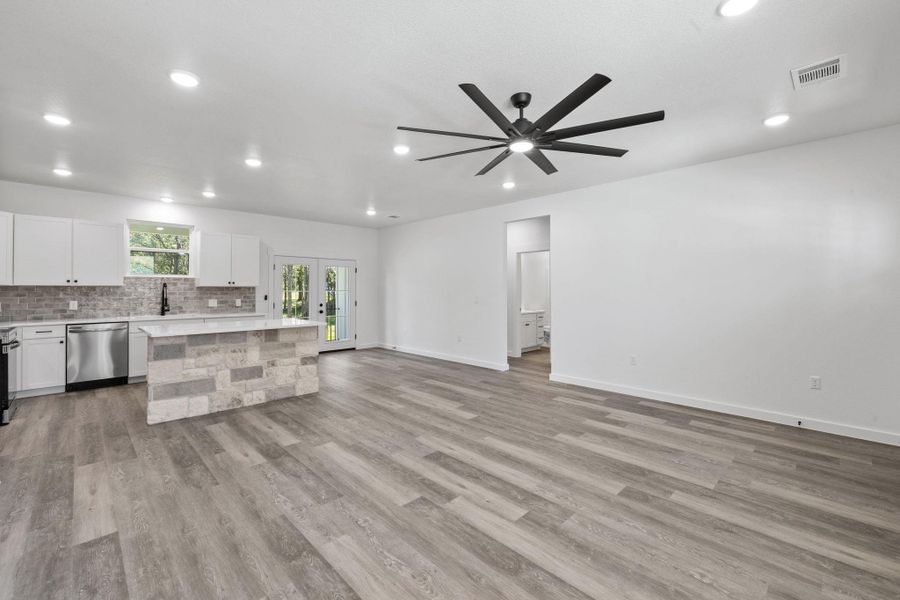 A contemporary open-concept layout unites the sleek kitchen and versatile living space, anchored by a distinctive stone-clad island. A contemporary open-concept layout unites the sleek kitchen and versatile living space, anchored by a distinctive stone-clad island.