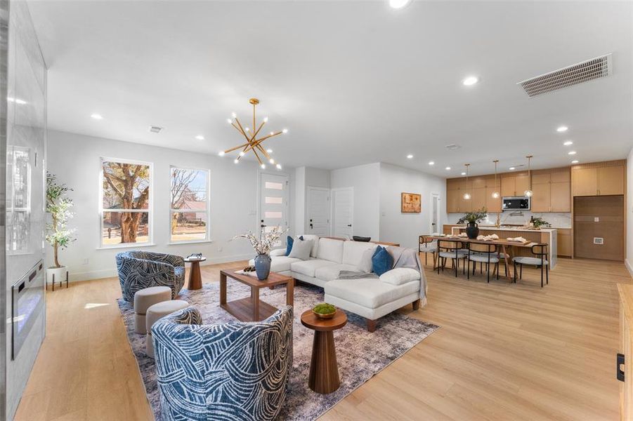 Living room featuring hanging lights and light wood-type flooring