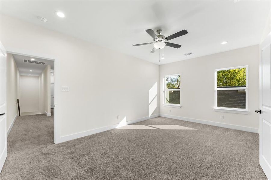 Empty room with light colored carpet, recessed lighting, and ceiling fan Empty room with light colored carpet, recessed lighting, and ceiling fan