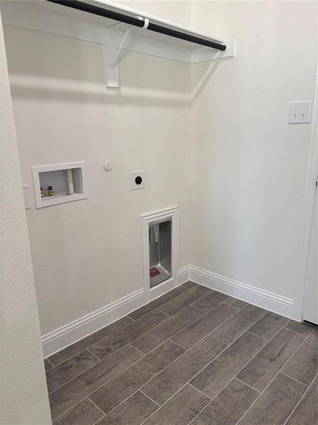 Laundry room with washer hookup, wood finish floors, electric dryer hookup, laundry area, and baseboards