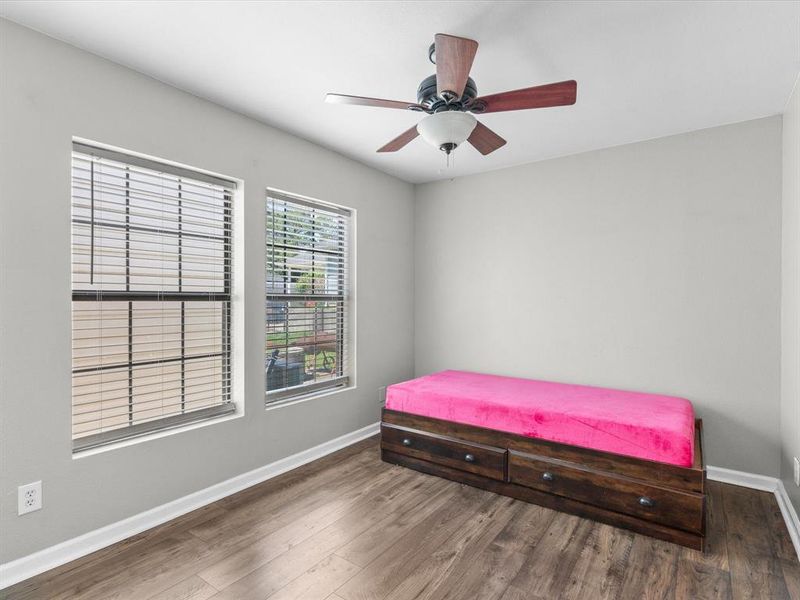 Bedroom featuring wood finished floors and a ceiling fan Bedroom featuring wood finished floors and a ceiling fan