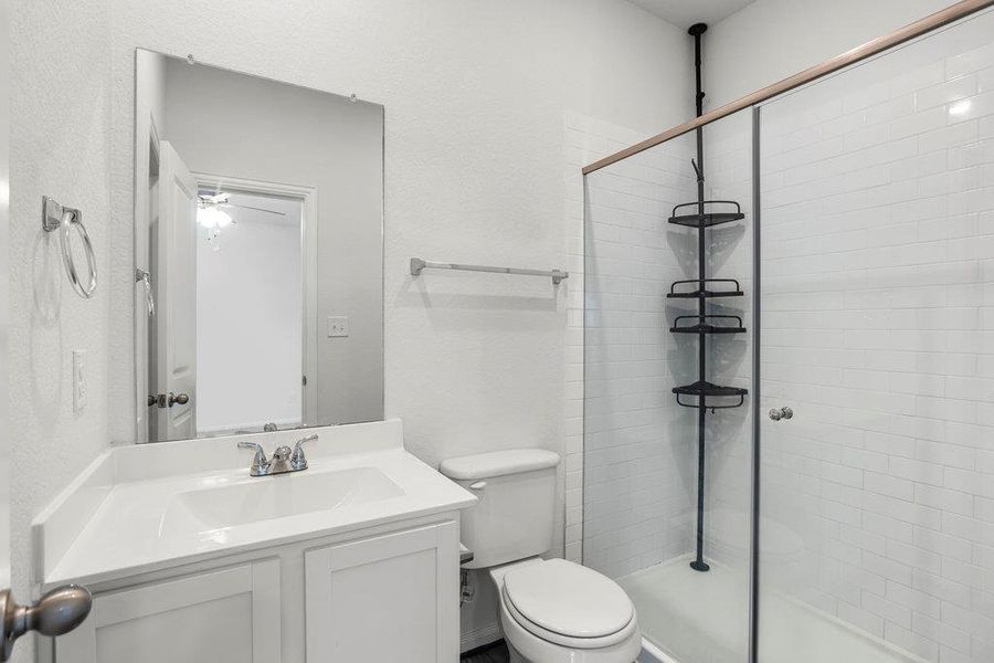 Full bath with vanity and a shower stall