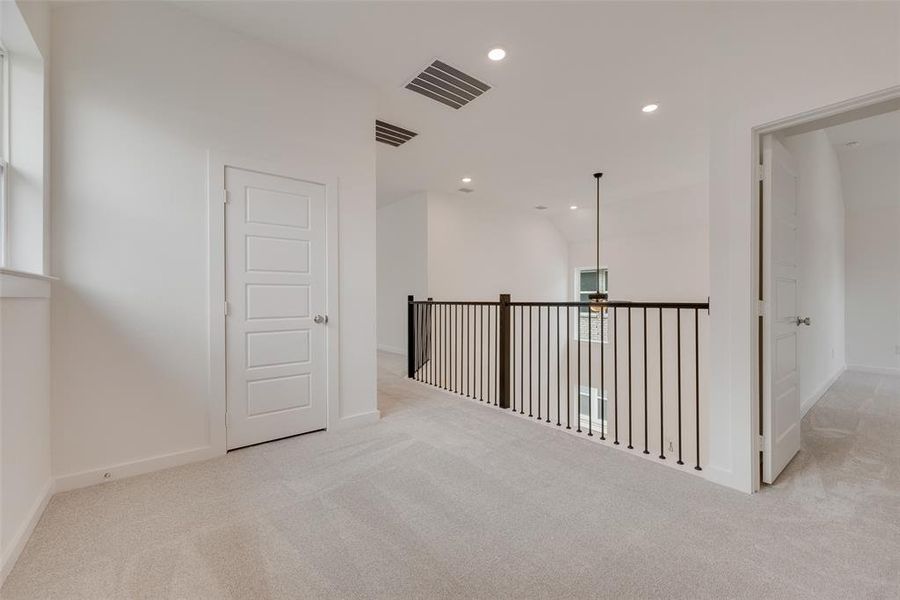 Spare room featuring light carpet and recessed lighting Spare room featuring light carpet and recessed lighting