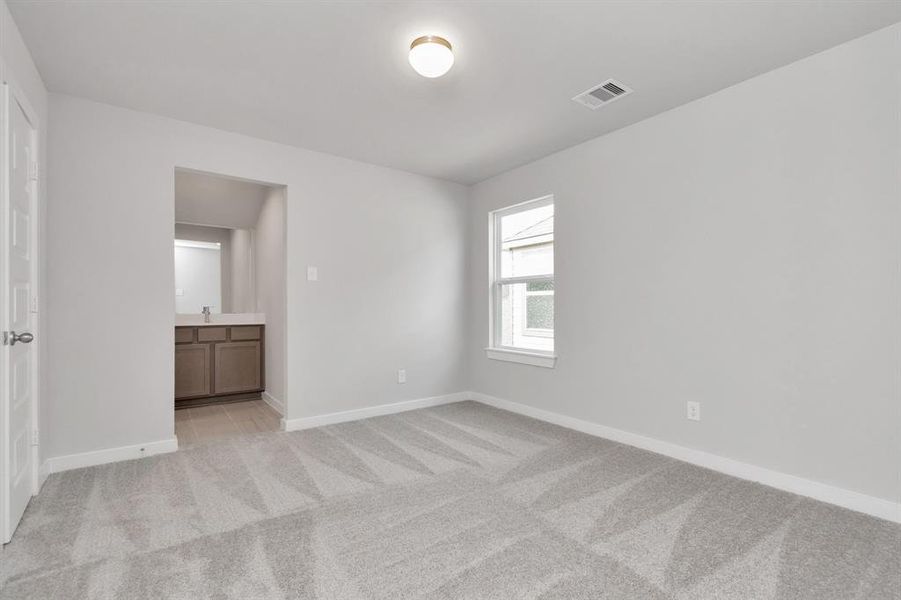 Secondary bedroom features plush carpet, custom paint, large window with privacy blinds and access to the Jack and Jill bath. Sample photo of completed home with similar floor plan. Actual colors and selections may vary.