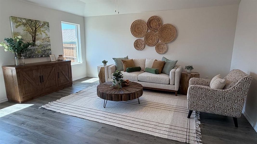 Living area featuring baseboards and dark wood-style flooring