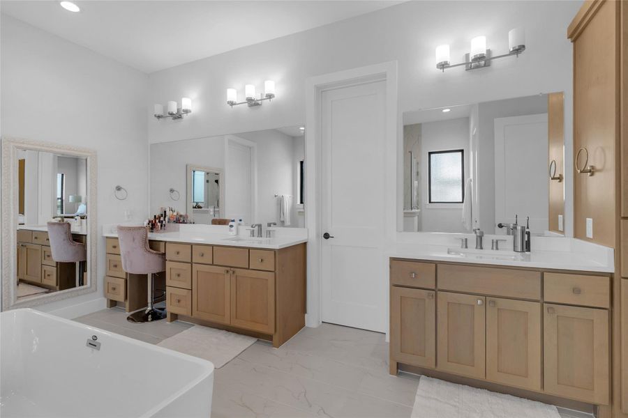 Dual vanities in the spacious primary bathroom.