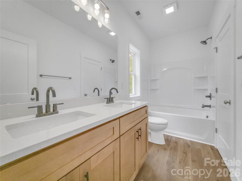 Full bathroom upstairs with dual vanity and quartz counters Full bathroom upstairs with dual vanity and quartz counters
