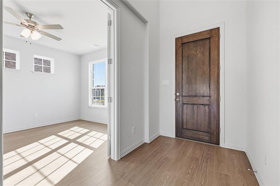 Entryway with light wood-style flooring and a ceiling fan Entryway with light wood-style flooring and a ceiling fan