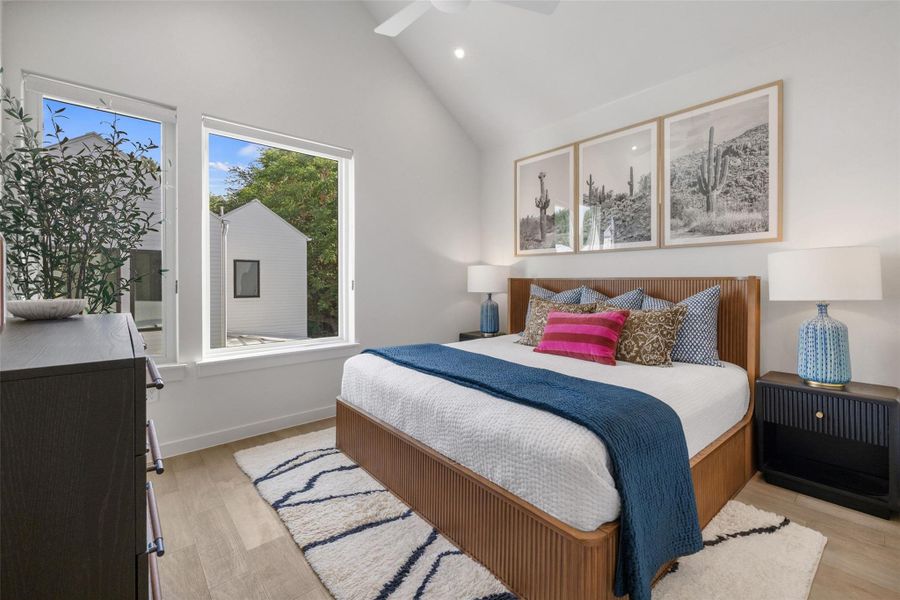 Bedroom with light wood-type flooring, recessed lighting, lofted ceiling, and a ceiling fan