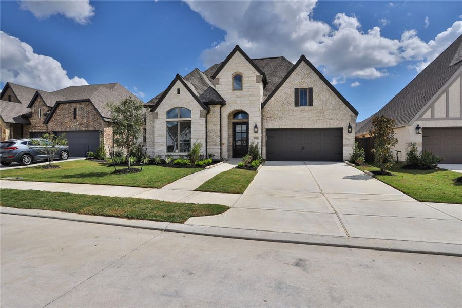 Front exterior of a new home in Riceland 60', Mont Belvieu, TX, highlighting curb appeal (Image 1). Front exterior of a new home in Riceland 60', Mont Belvieu, TX, highlighting curb appeal (Image 1).