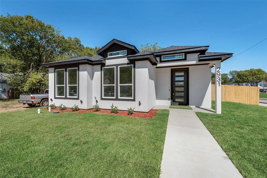 Prairie-style home featuring a front lawn