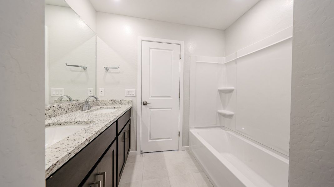 A bathroom with a marble countertop.