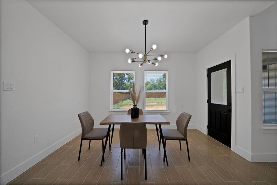 Dining area featuring tiled floors and a chandelier