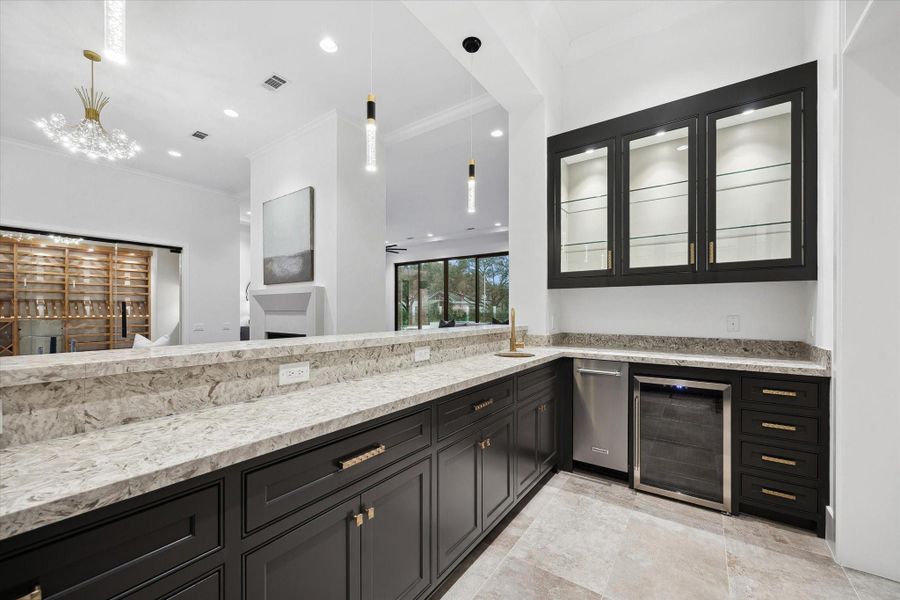 Expansive wet bar designed for effortless entertaining, featuring generous countertop space, abundant custom cabinetry, and sleek drawers—combining style and function in a true entertainer’s dream.