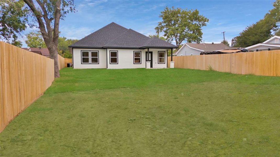 Rear view of house with a lawn