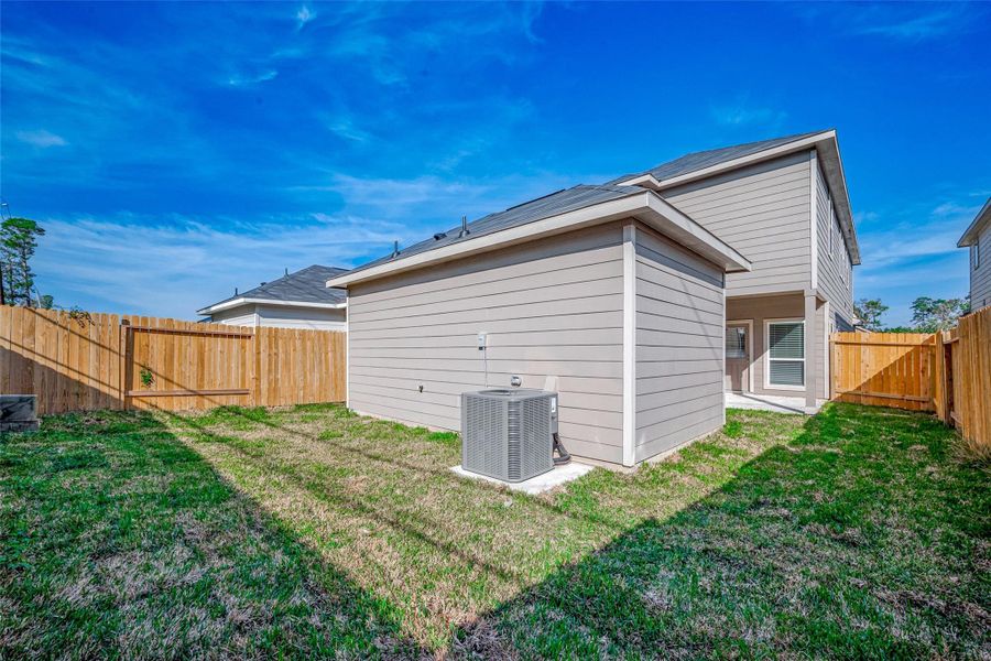 Exterior details and patio area of a home in Woodland Lakes, Huffman (Image 15). Exterior details and patio area of a home in Woodland Lakes, Huffman (Image 15).