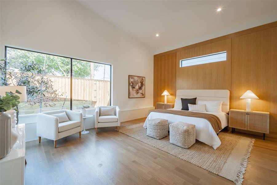 Bedroom featuring high vaulted ceiling and light hardwood / wood-style floors