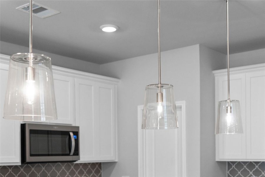 Clarion Brushed Nickel pendant lights that hang over the kitchen island. Clarion Brushed Nickel pendant lights that hang over the kitchen island.